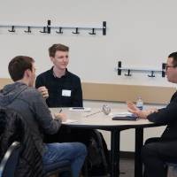 An alumnus giving advice to students at the 30 Minute Mentors Event